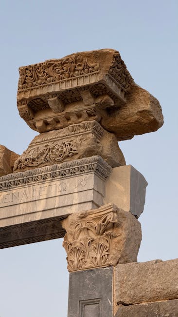 Close-up of ancient stone ruins with intricate carvings under a clear sky.